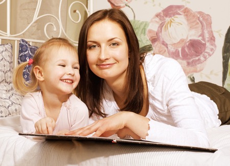Portrait of mother and daughter lat home, happy familyの写真素材