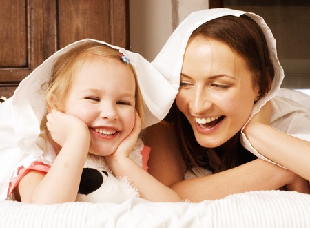 Portrait of mother and daughter lat home, happy familyの写真素材