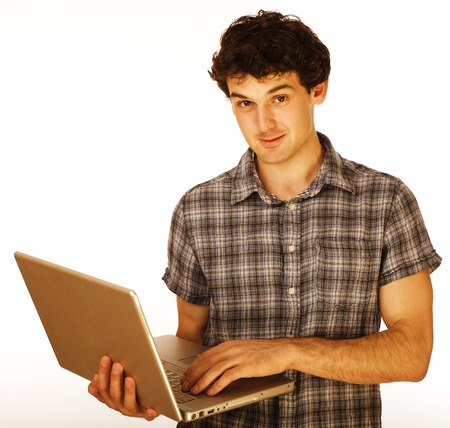 Happy young man with laptop isolated on white, smiling teen studentの写真素材