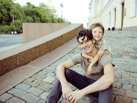 little son with father in city hagging and smiling, casual lookの写真素材
