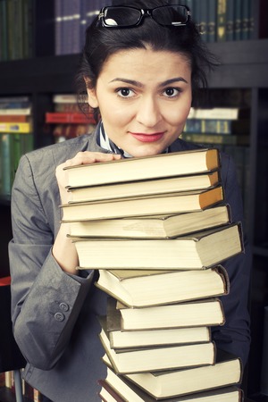 stock photo portrait of beauty young woman reading book in library smilingの写真素材