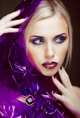 beauty woman with creative make up, many fingers on face close upの写真素材
