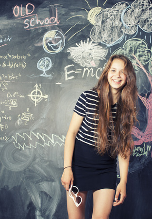 back to school after summer vacations, cute teen real girl in classroomの写真素材
