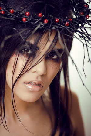 pretty brunette woman with make up like demon at halloween, closeupの写真素材