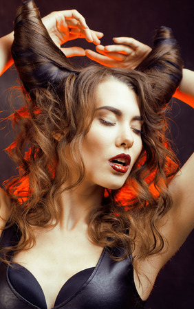 bright mysterious woman with horn hair, halloween celebration close upの写真素材