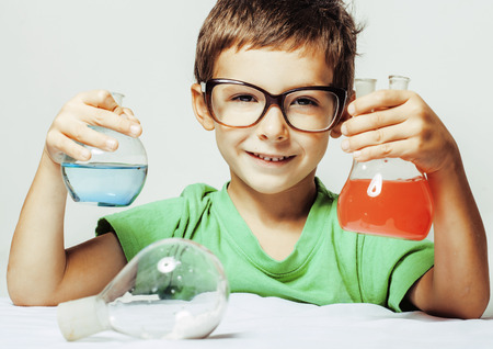 little cute boy with medicine glass isolated wearing glasses smilingの写真素材