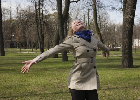 real happy blonde girl in park hands up, enjoying happinessの写真素材