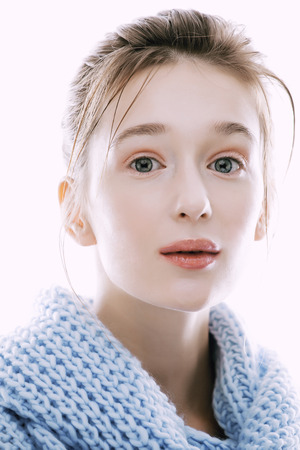 beauty young blond woman in scarf with weathered lips close up isolatedの写真素材