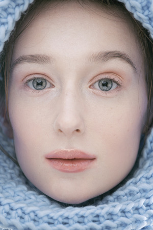 beauty young blond woman in scarf with weathered lips close up isolatedの写真素材