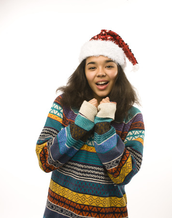 cute young girl in santas red hat isolated, waiting for Christmasの写真素材
