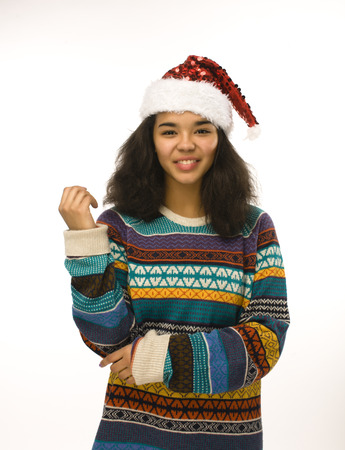 cute young girl in santas red hat isolated, waiting for Christmasの写真素材