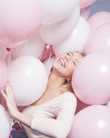 young happy blonde woman with baloons smiling close upの写真素材