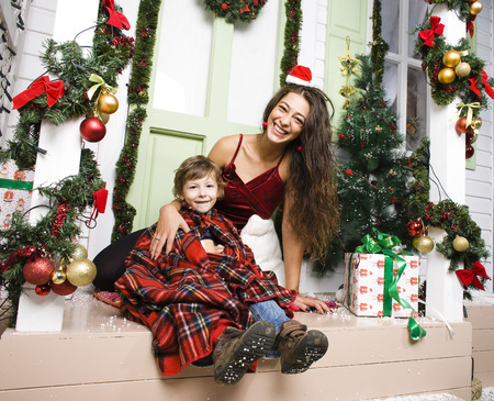 happy family on Christmas in red hats waiting gests and smiling at homeの写真素材