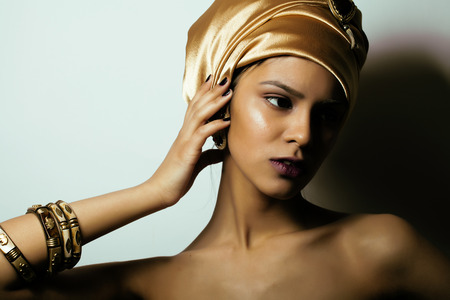 beauty african woman in shawl on head, very elegant look with gold jewelry close upの写真素材