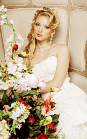 beauty young bride alone in luxury vintage interior with a lot of flowers close upの写真素材