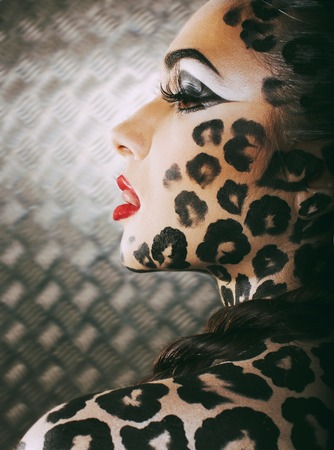 young sexy woman with leopard make up all over body, cat bodyart closeupの写真素材