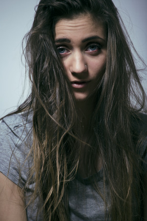 problem depressioned teenage with messed hair and sad face, junkyの写真素材