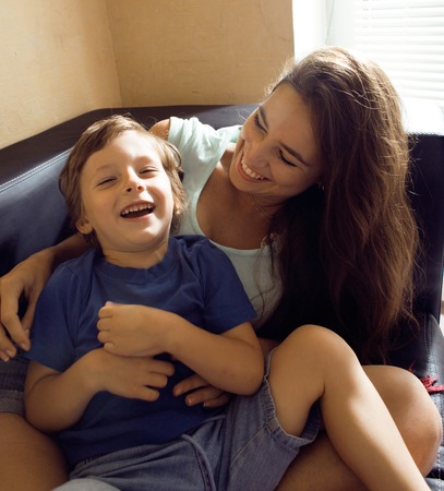 mother with son, happy family at home interiorの写真素材