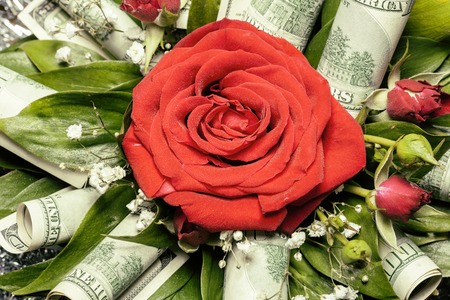 red rose in bouquet decorated with hundred dollars notes, ideal gift for celebration christmas and new yearの写真素材