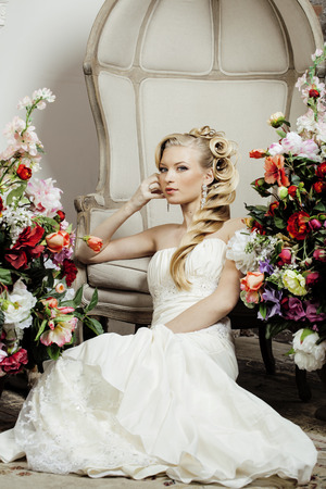 beauty young bride alone in luxury vintage interior with a lot of flowers close upの写真素材