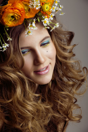 Beauty young woman with flowers and make up close up, real spring beauty girl curly hair, sweetの写真素材