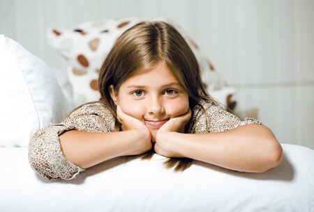 real little cute brunette girl at home smiling close upの写真素材