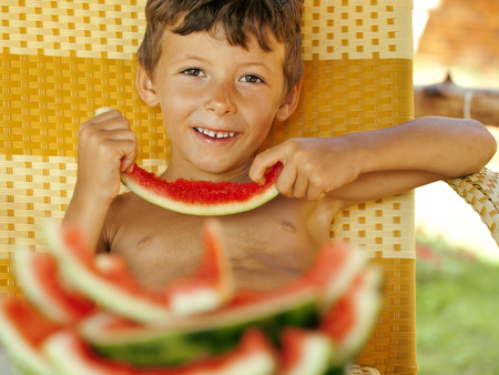 cute young little boy with watermelonの写真素材