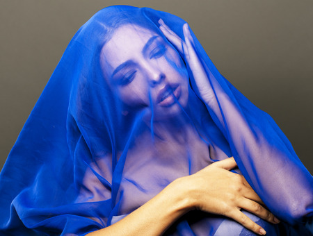 beauty young islamic woman under veil, blue hijab on face close upの写真素材
