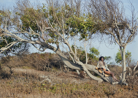 beauty young woman in savanna walking, dreaming, making notes, trip alone