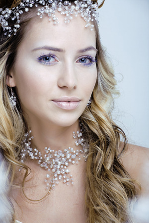beauty young snow queen in fairy flashes with crown on her head close upの写真素材