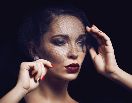 beauty brunette woman under black veil with red manicure close up, grieving widow, halloween makeupの写真素材