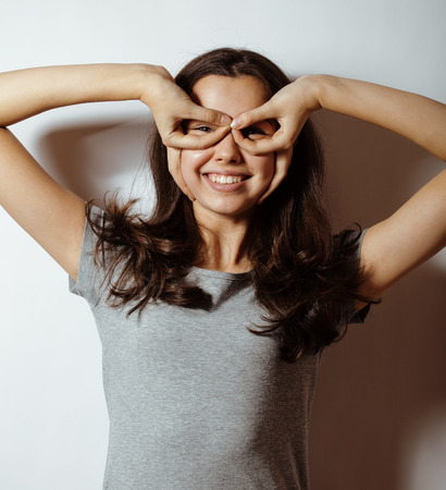 young pretty girl on white background gesturing adorable close upの写真素材