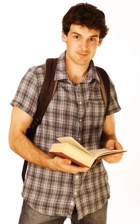 young handsome man with book and backpack isolated on whiteの写真素材