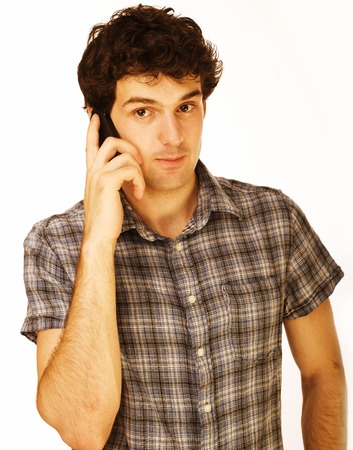 Portrait of handsome young man using cellphone isolated on whiteの写真素材