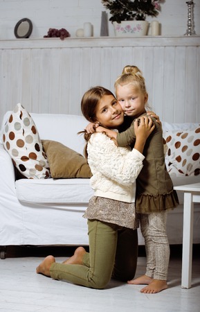 two cute sisters playing at homeの写真素材
