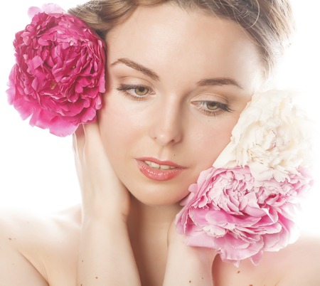 young beauty woman with flower peony pink closeup makeup soft tender gentle look on whiteの写真素材