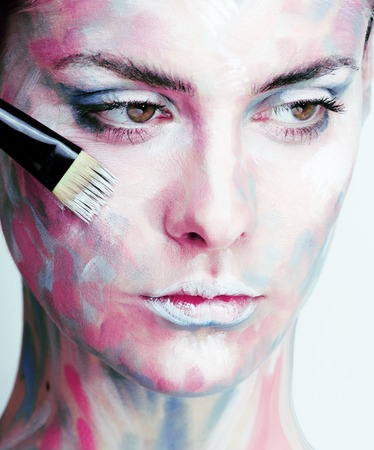 young woman with creative make up like painted oil picture on face closeupの写真素材