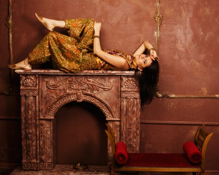 portrait of beauty sensual young woman in oriental style  luxury roomの写真素材