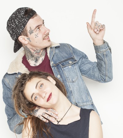 young couple together. guy with tattoo, girlfriend wearing dreadlocks having funの写真素材