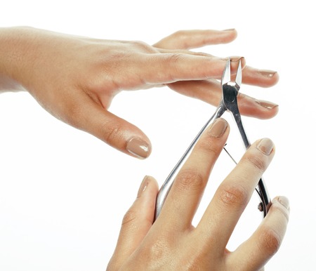 woman hands making no qualified manicure to herself isolated with tools