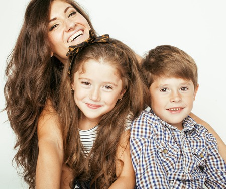 young mother with two children on white, happy smiling family insideの写真素材