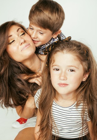 young mother with two children on white, happy smiling family insideの写真素材