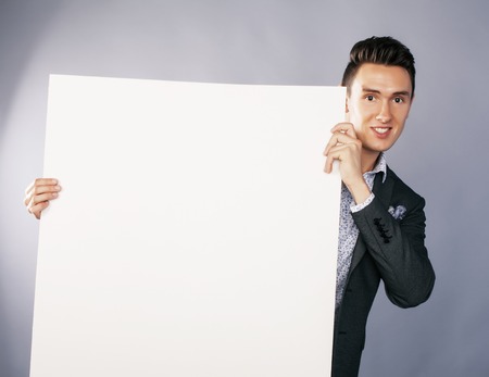 young handsom businessman in suit with poster empty copy space smiling