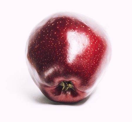 attractive teasing red apple close up isolated on white backgroundの写真素材