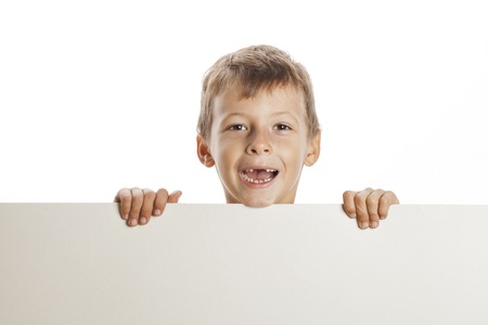 little cute boy holding empty plate to copyspace isolated close up gesturing smilingの写真素材