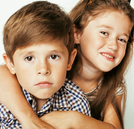 little cute boy and girl hugging playing on white backgroundの写真素材