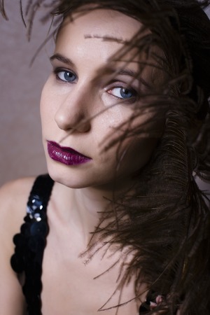 pretty woman with feather closeup fashion 1940-1980 make upの写真素材