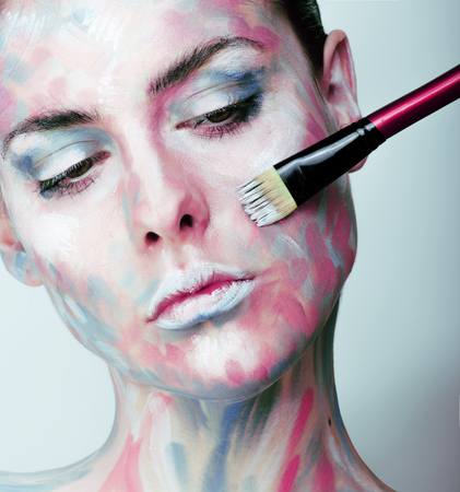 young woman with creative make up like painted oil picture on face closeupの写真素材