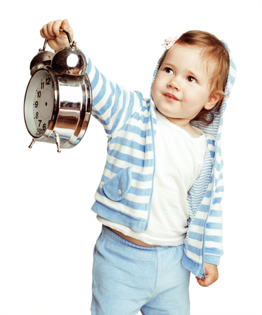 little cute girl in hood with clock alarm holding isolated on white background close upの写真素材