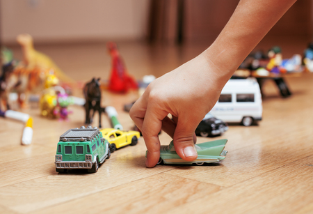 children playing toys on floor at home, little hand in mess, free educationの写真素材